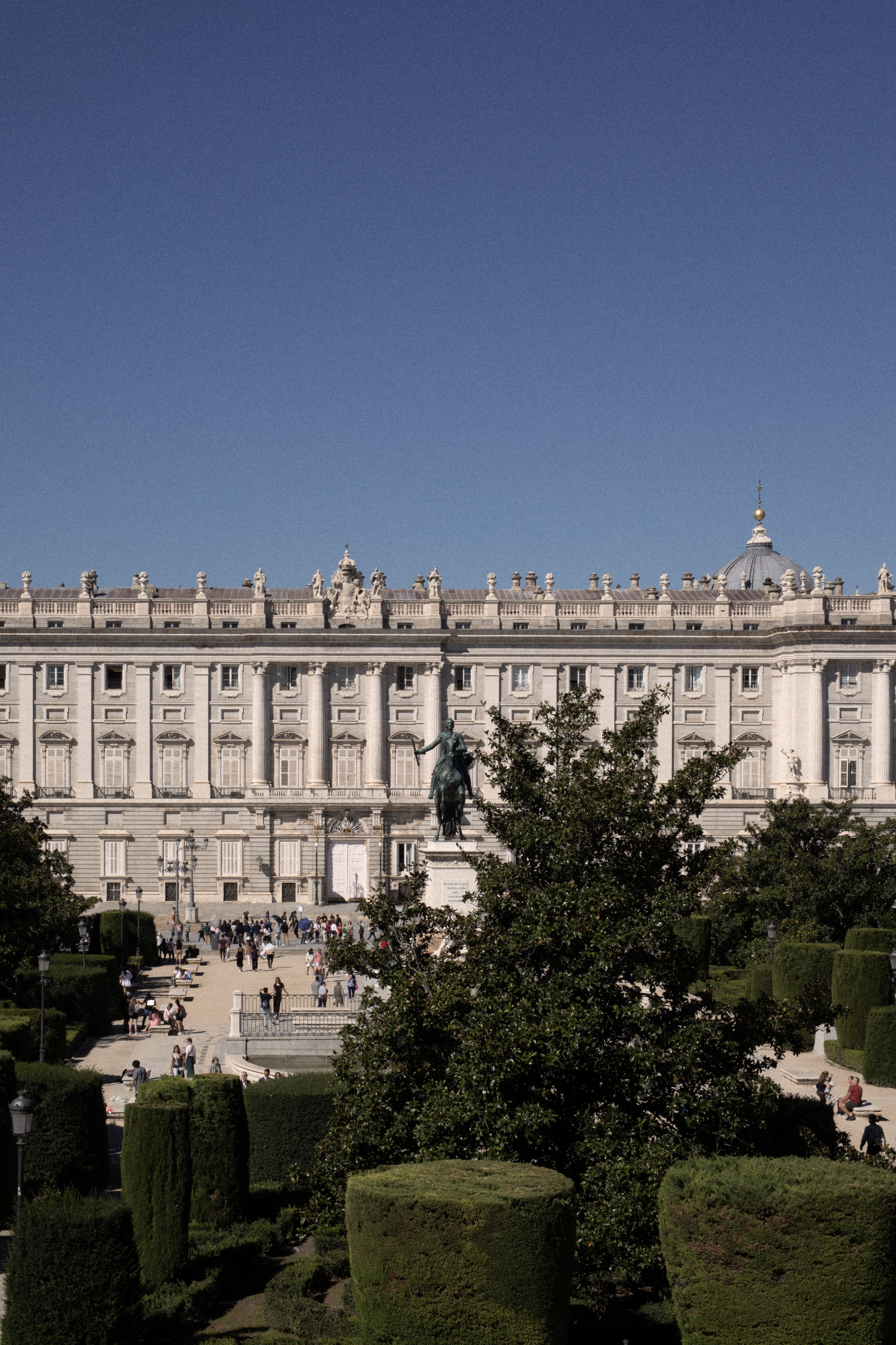a big white building with a statue in front