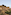 a stone building on a hill