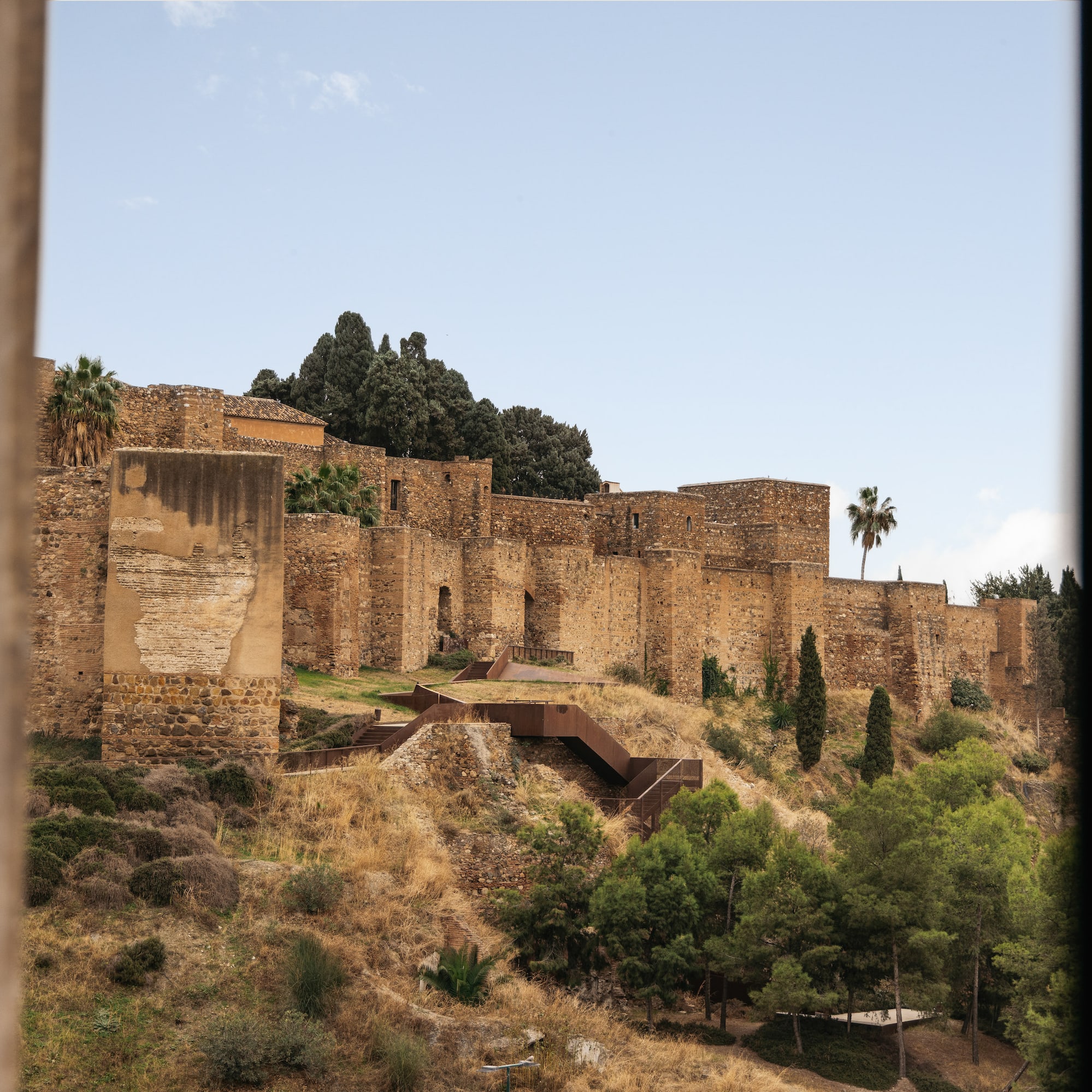 a stone building on a hill