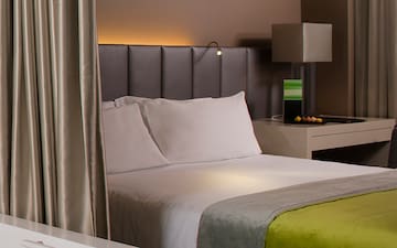 a bed with a green and yellow blanket