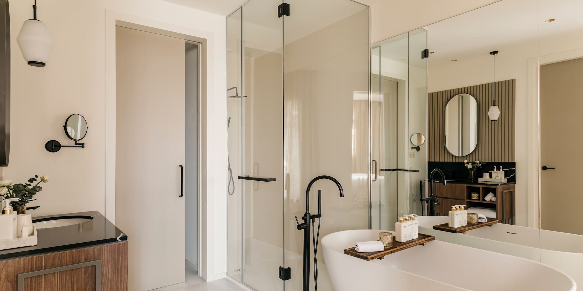 a bathroom with a tub and glass shower