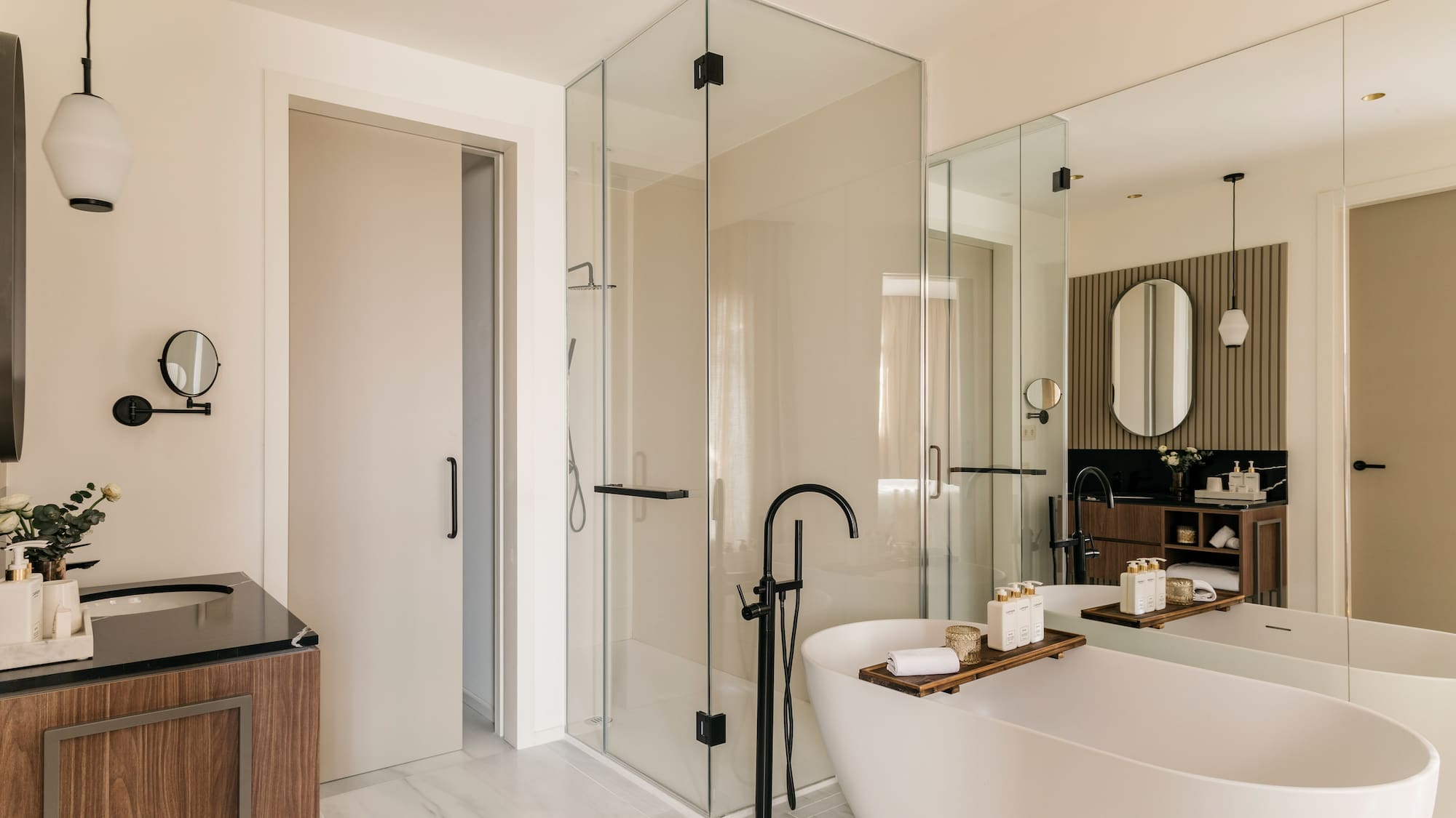 a bathroom with a tub and glass shower
