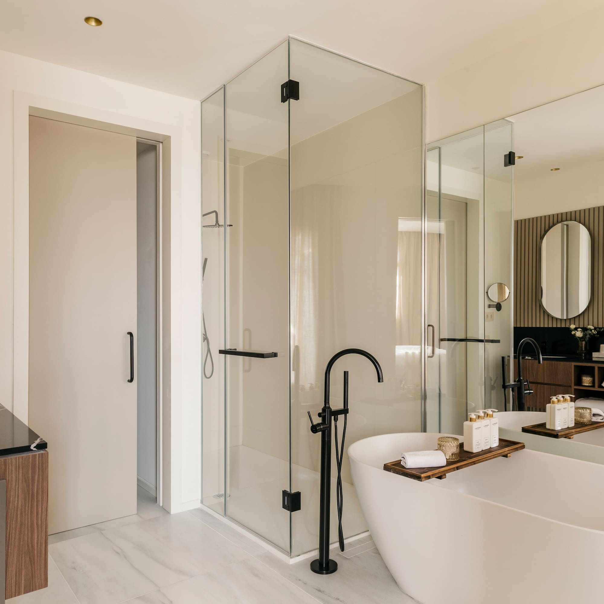 a bathroom with a tub and glass shower