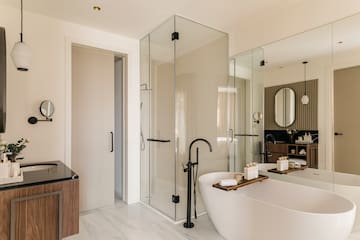 a bathroom with a tub and glass shower