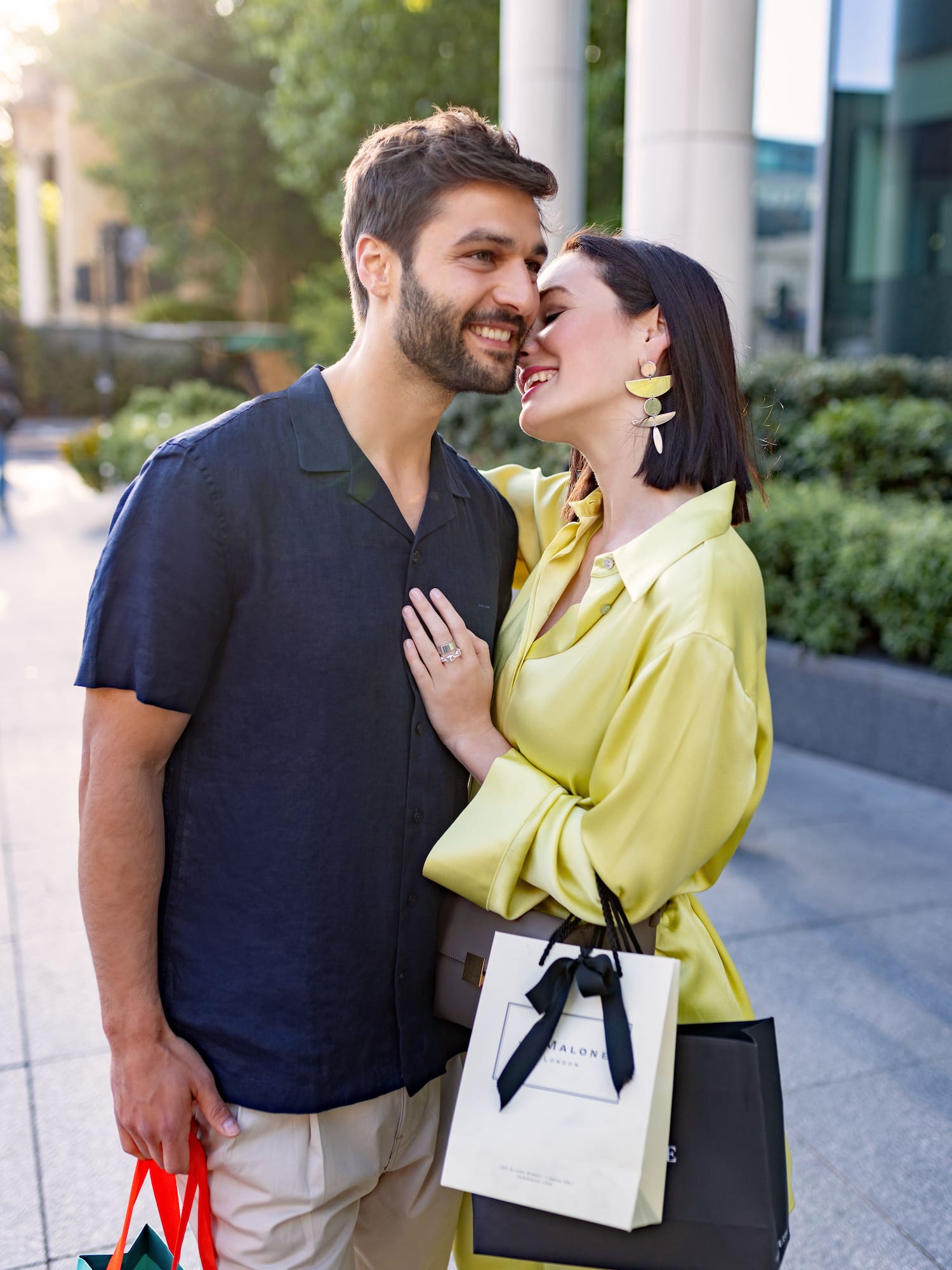a man and woman hugging and smiling