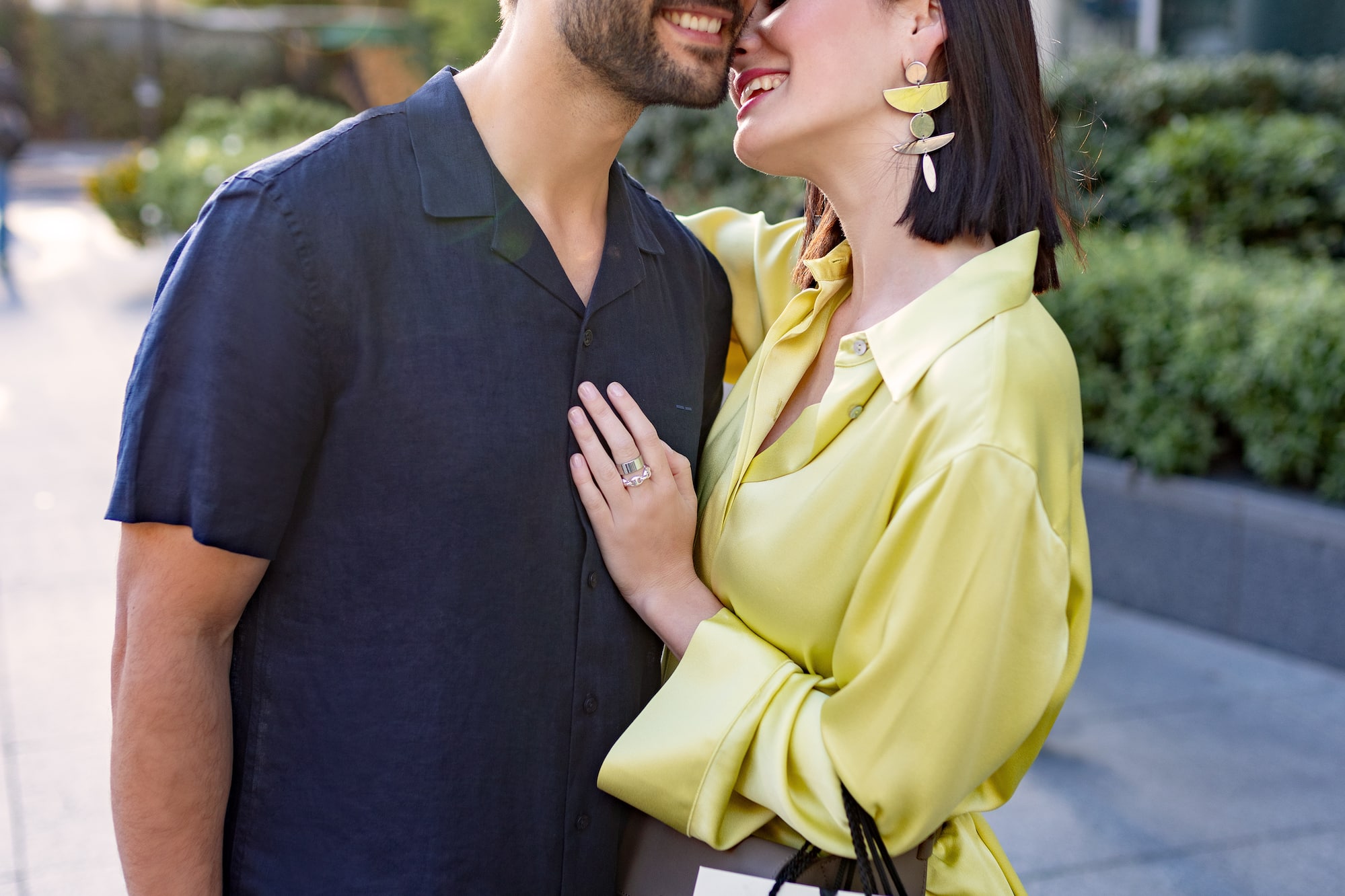 a man and woman hugging and smiling