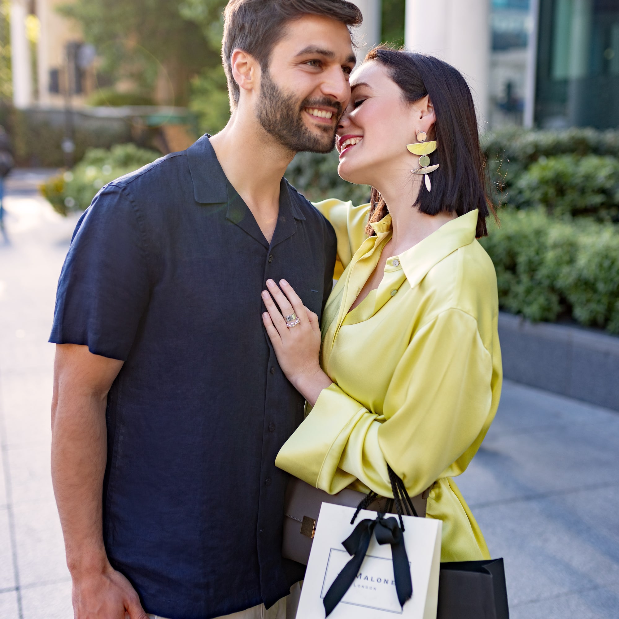 a man and woman hugging and smiling