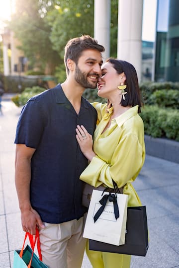 a man and woman hugging and smiling