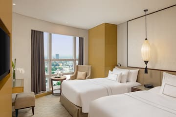 a room with two beds and a window