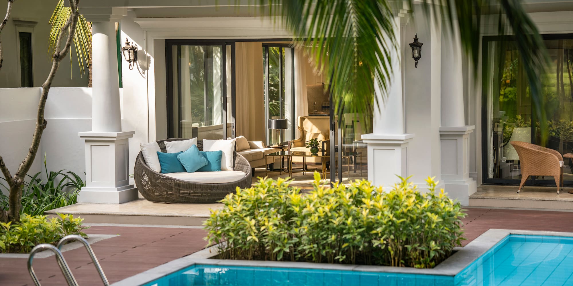 a pool with a couch and a chair in the middle