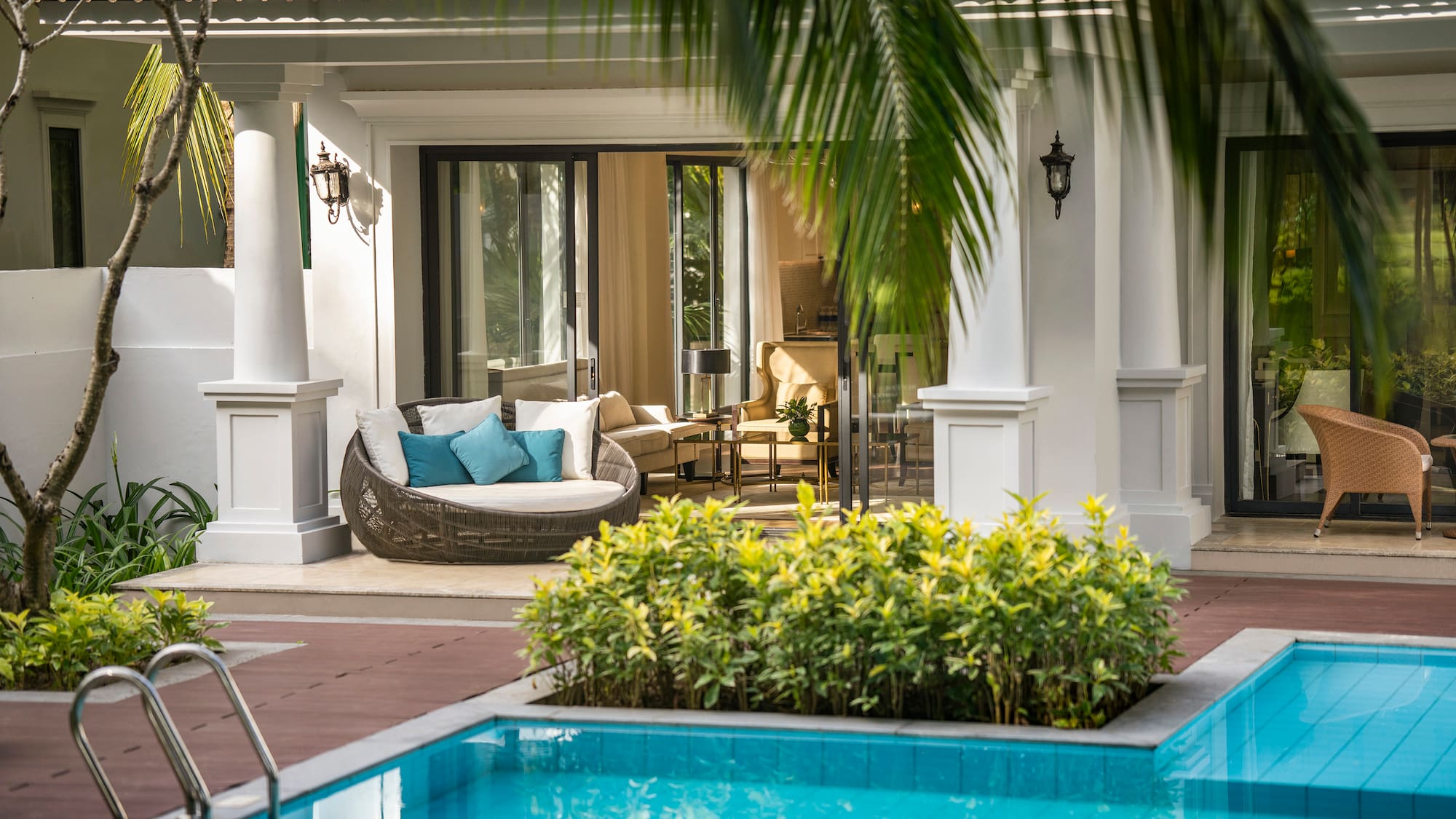 a pool with a couch and a chair in the middle