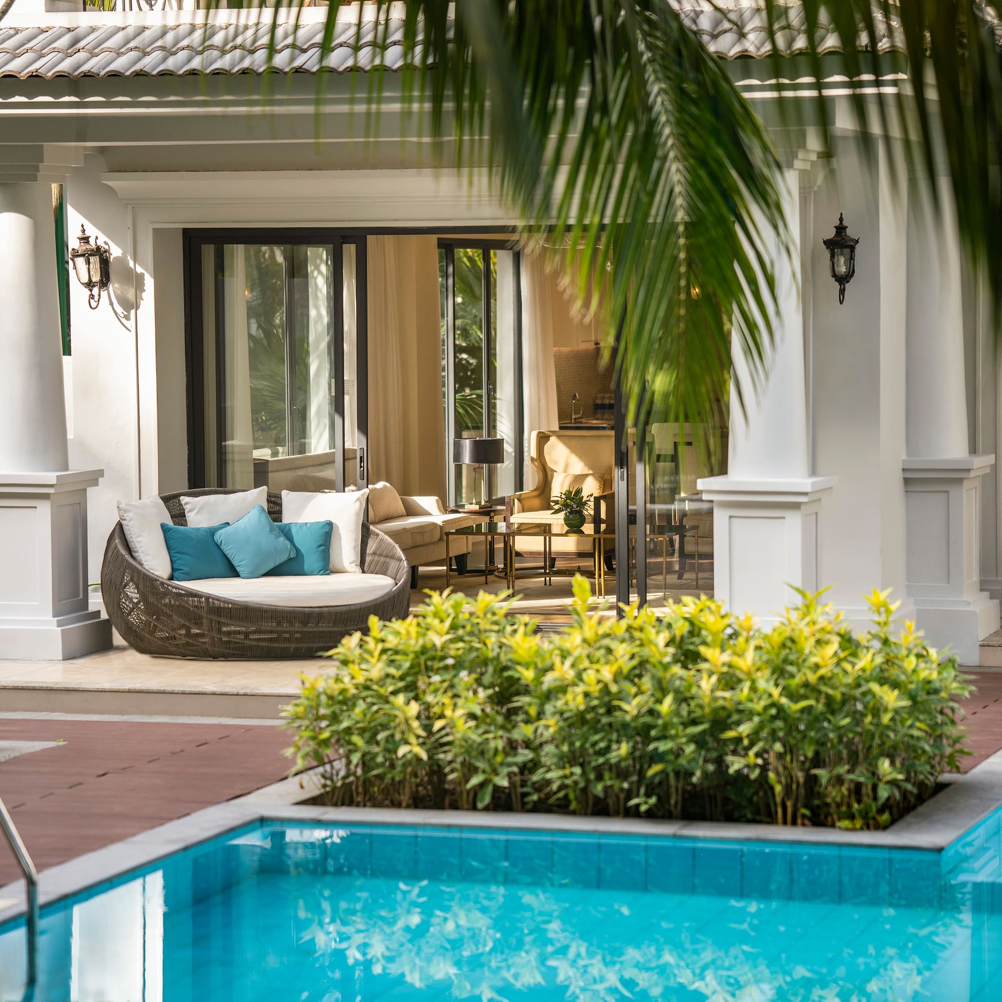 a pool with a couch and a chair in the middle