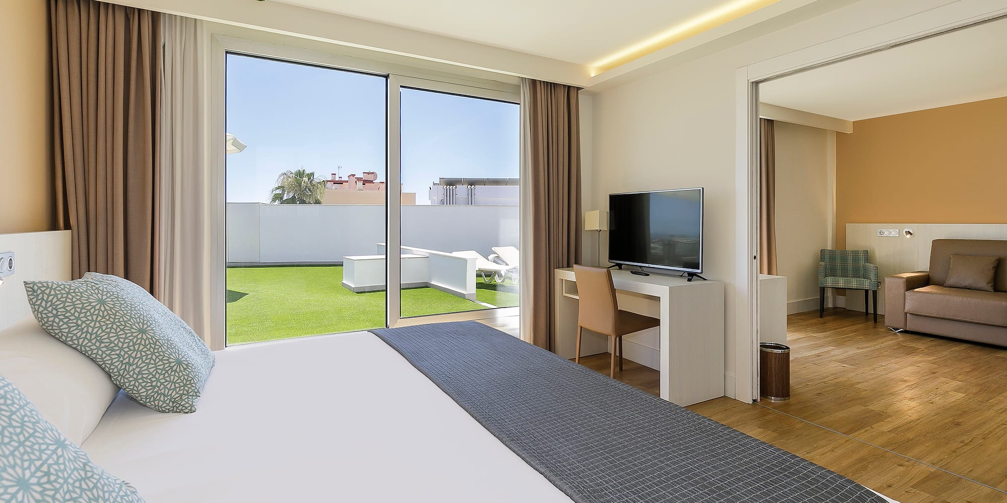 a bedroom with a large bed and a television