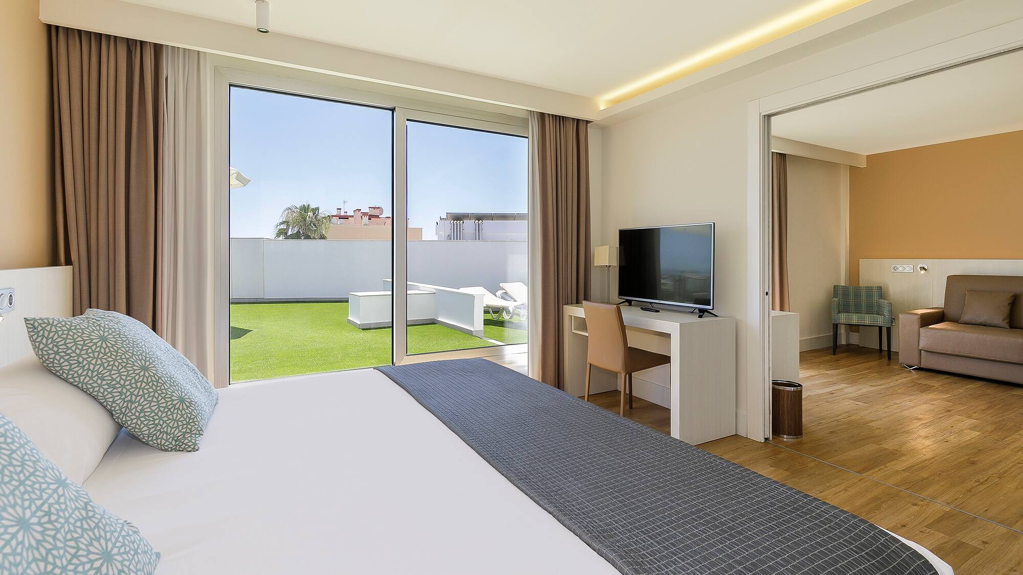 a bedroom with a large bed and a television