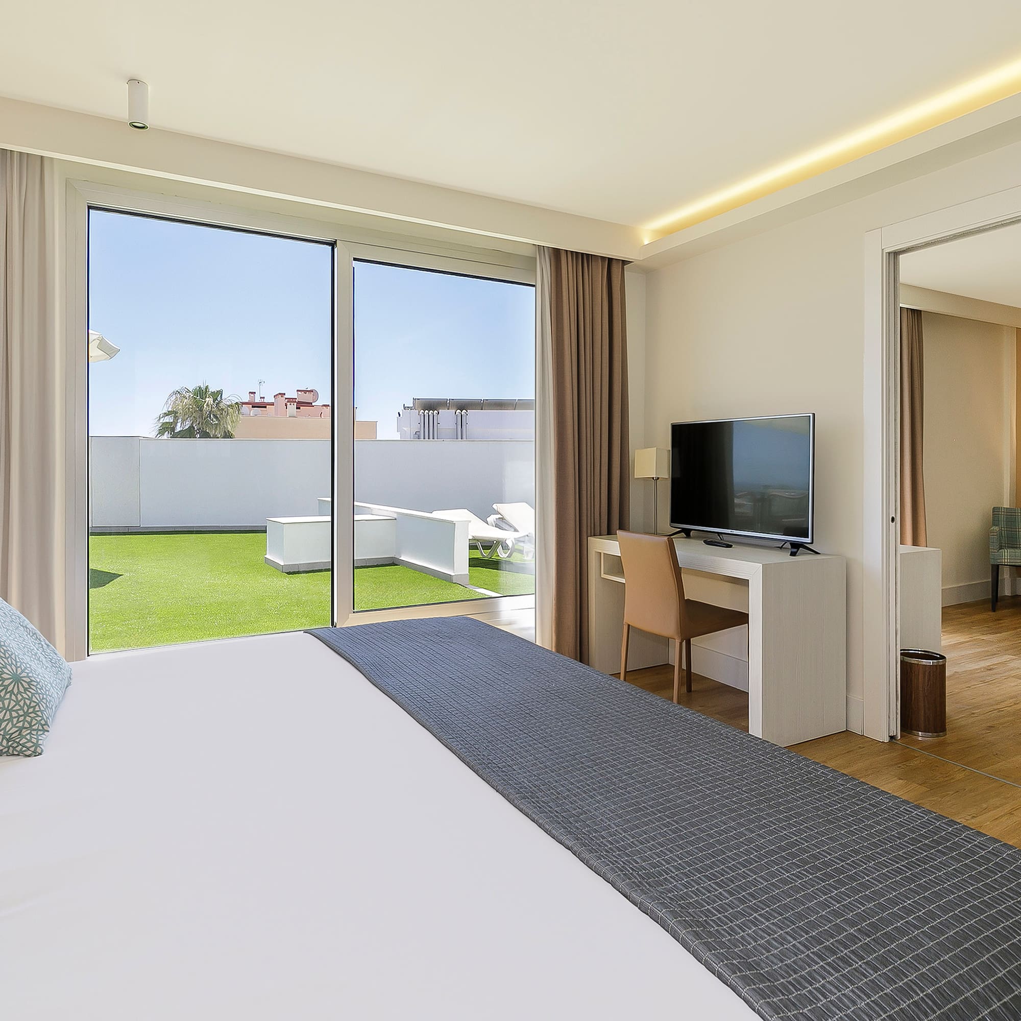 a bedroom with a large bed and a television