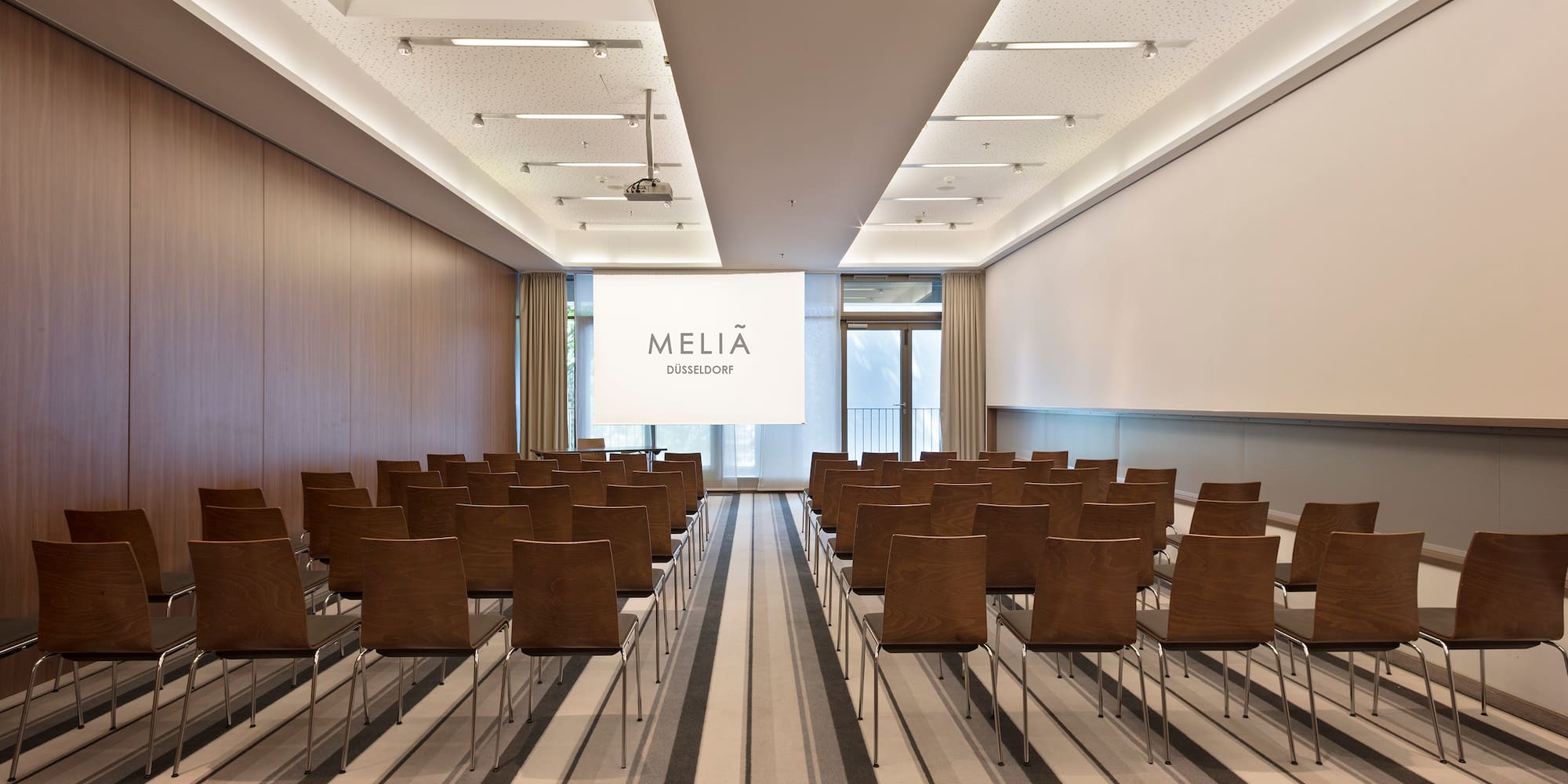 a room with chairs and a projector screen