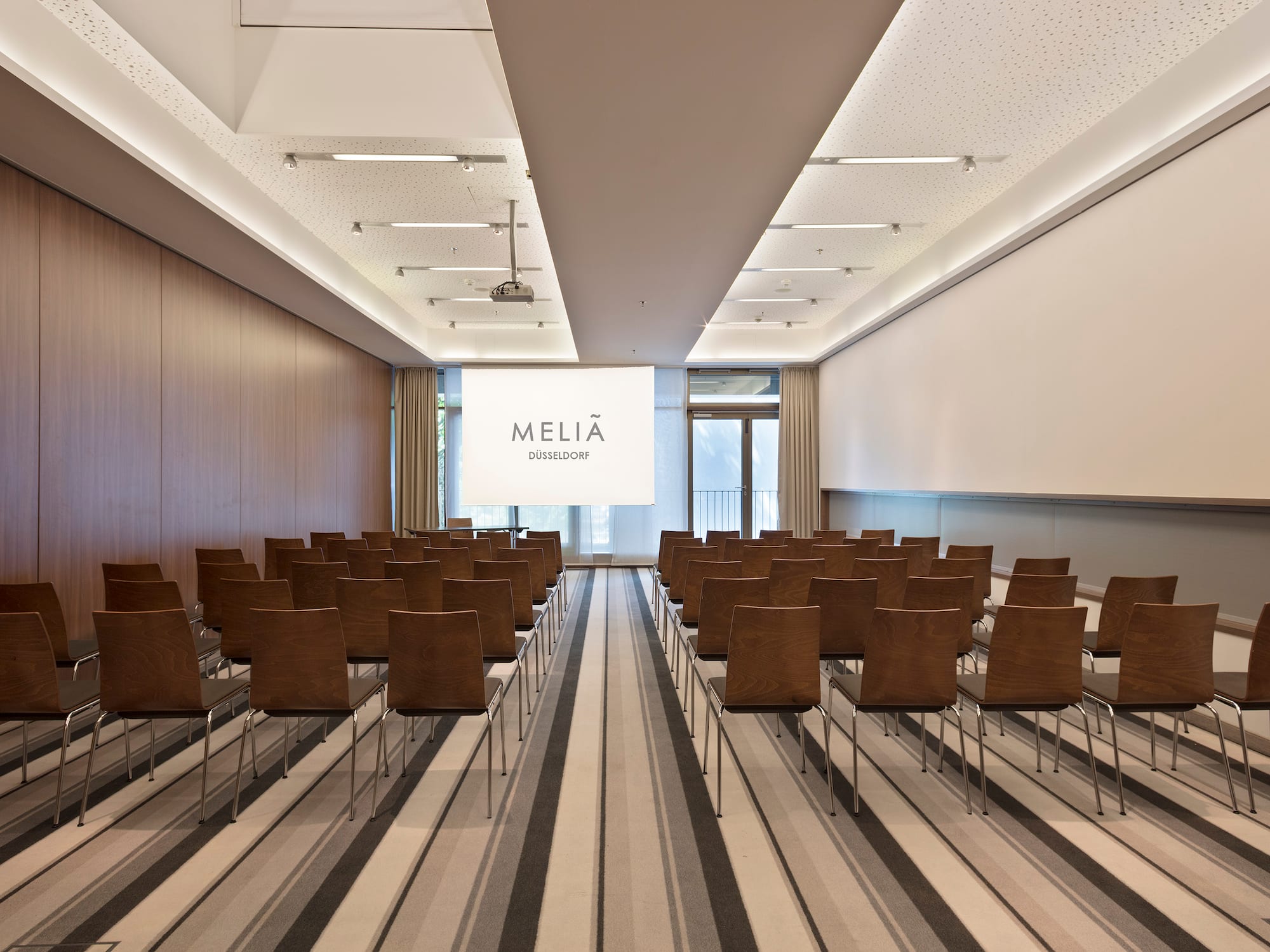 a room with chairs and a projector screen