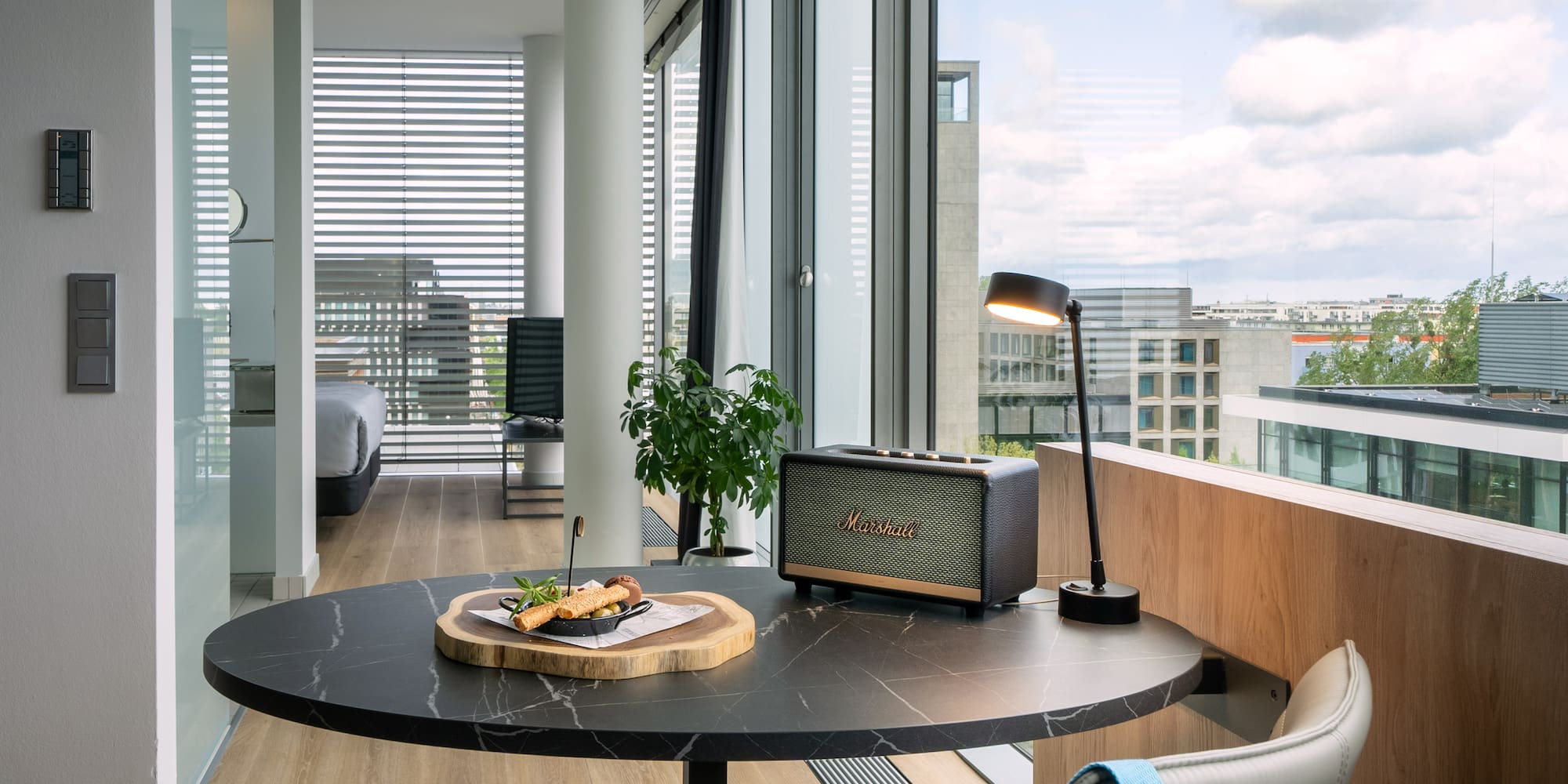 a table with food on it and a lamp in front of a window