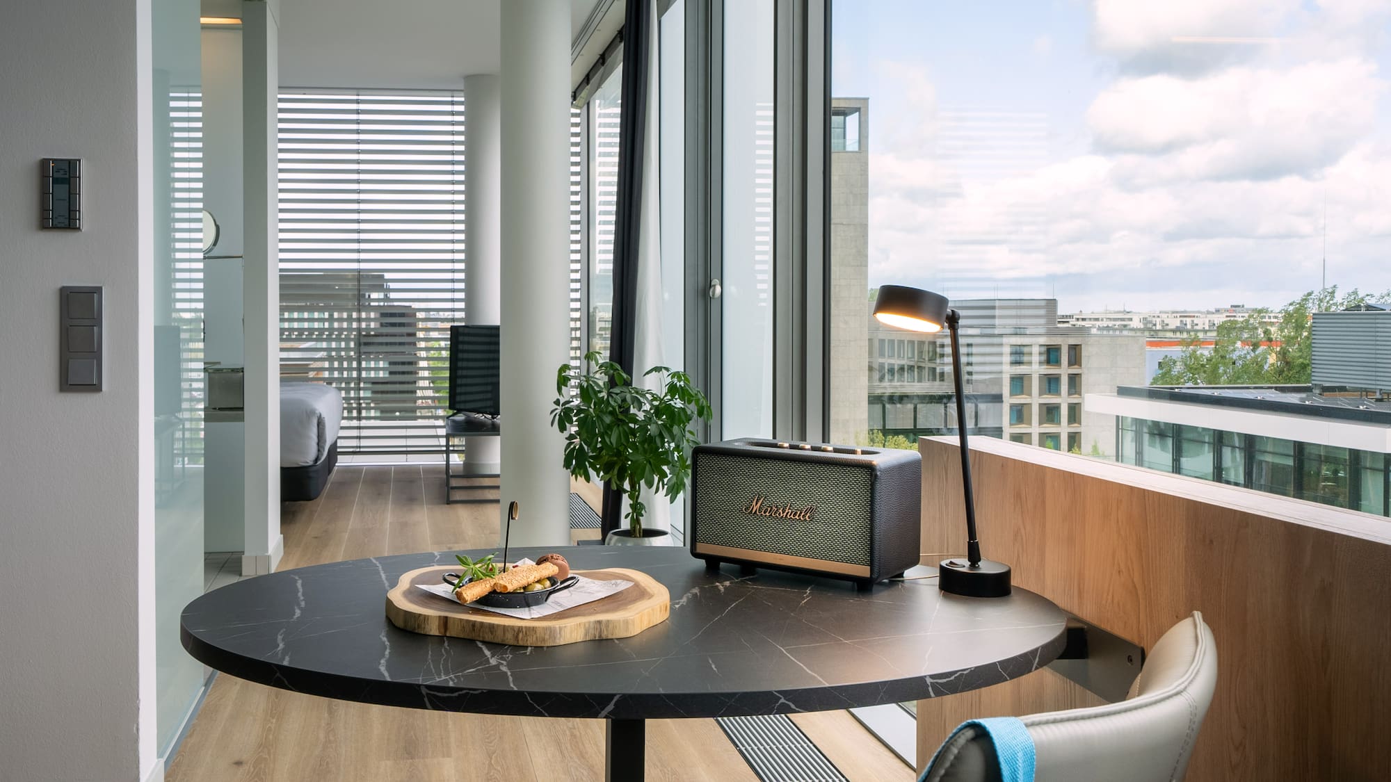 a table with food on it and a lamp in front of a window