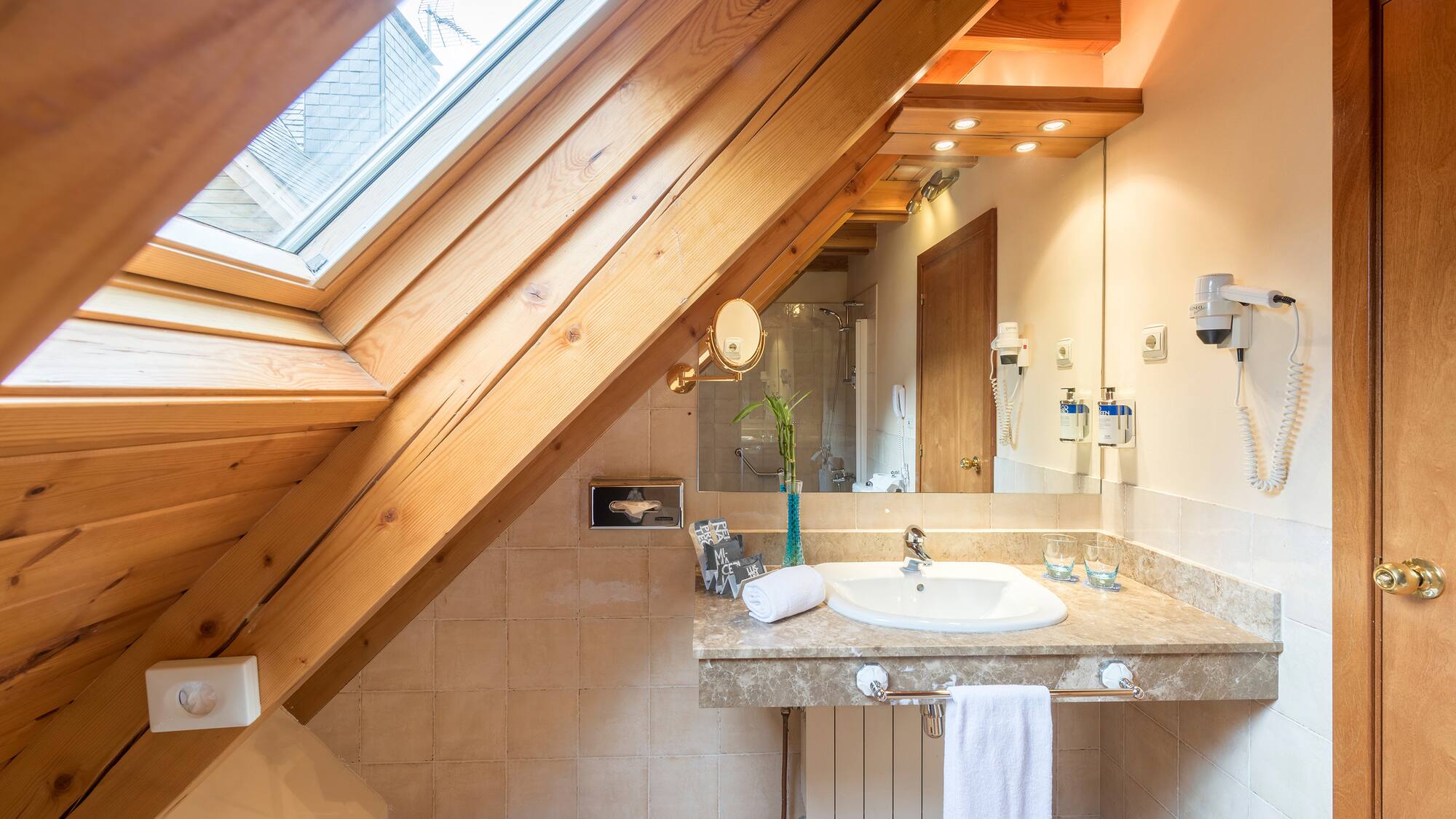 a bathroom with a wooden ceiling and a sink
