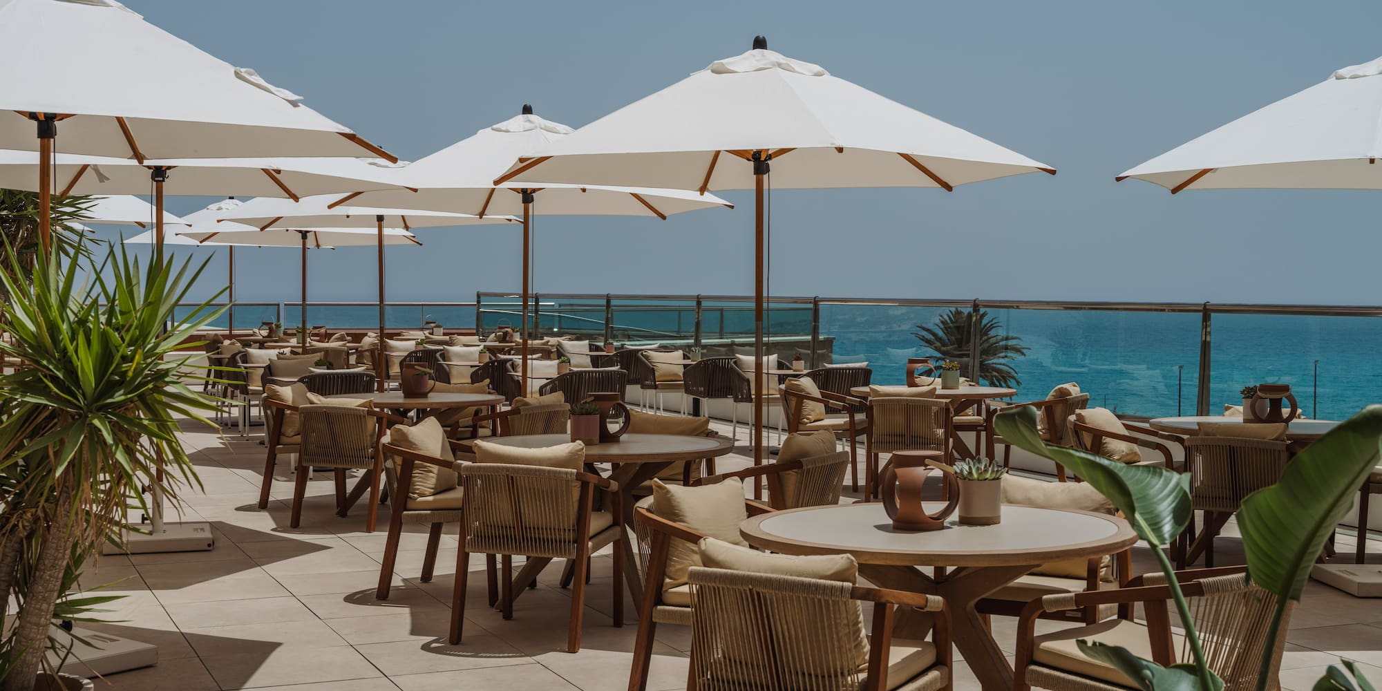 a patio with tables and umbrellas