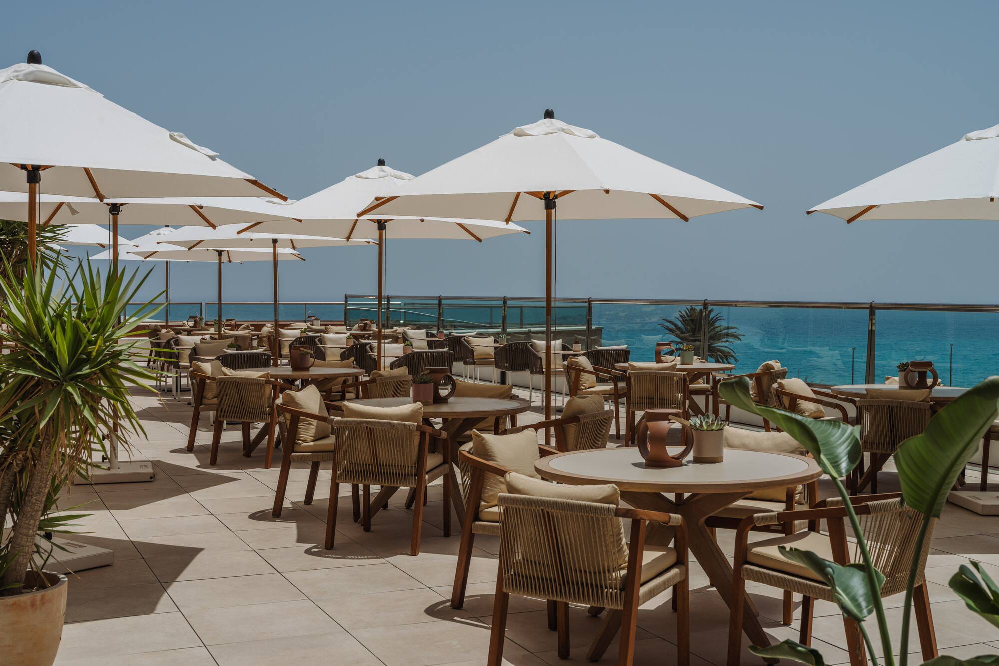 a patio with tables and umbrellas