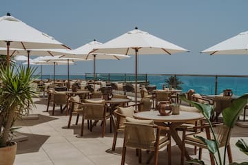 a patio with tables and umbrellas