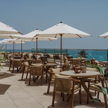 a patio with tables and umbrellas