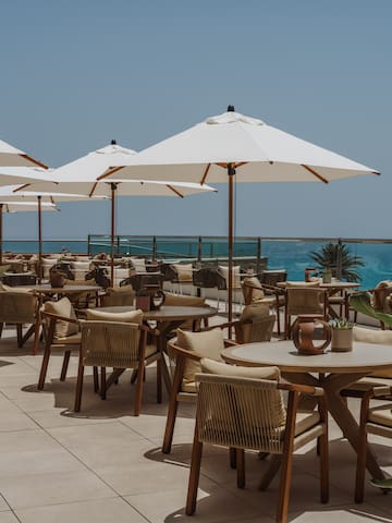 a patio with tables and umbrellas