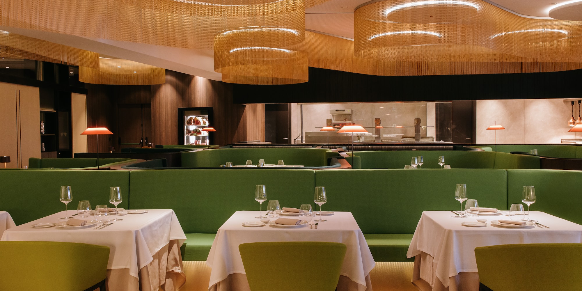 a restaurant with green benches and tables