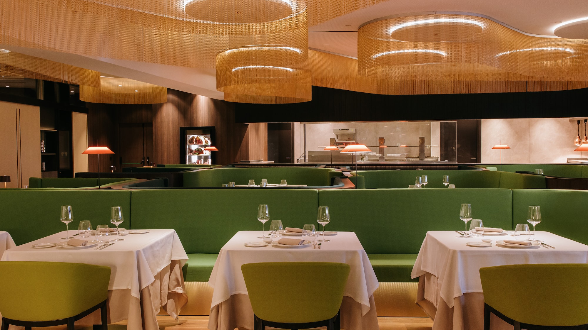 a restaurant with green benches and tables