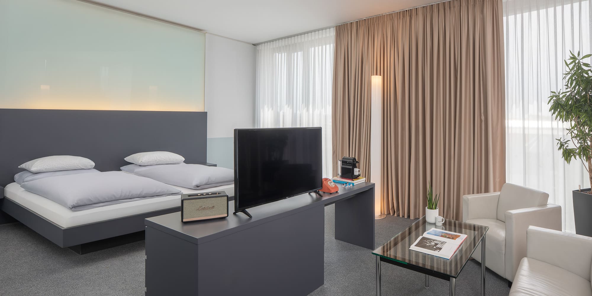 a room with a bed and a television