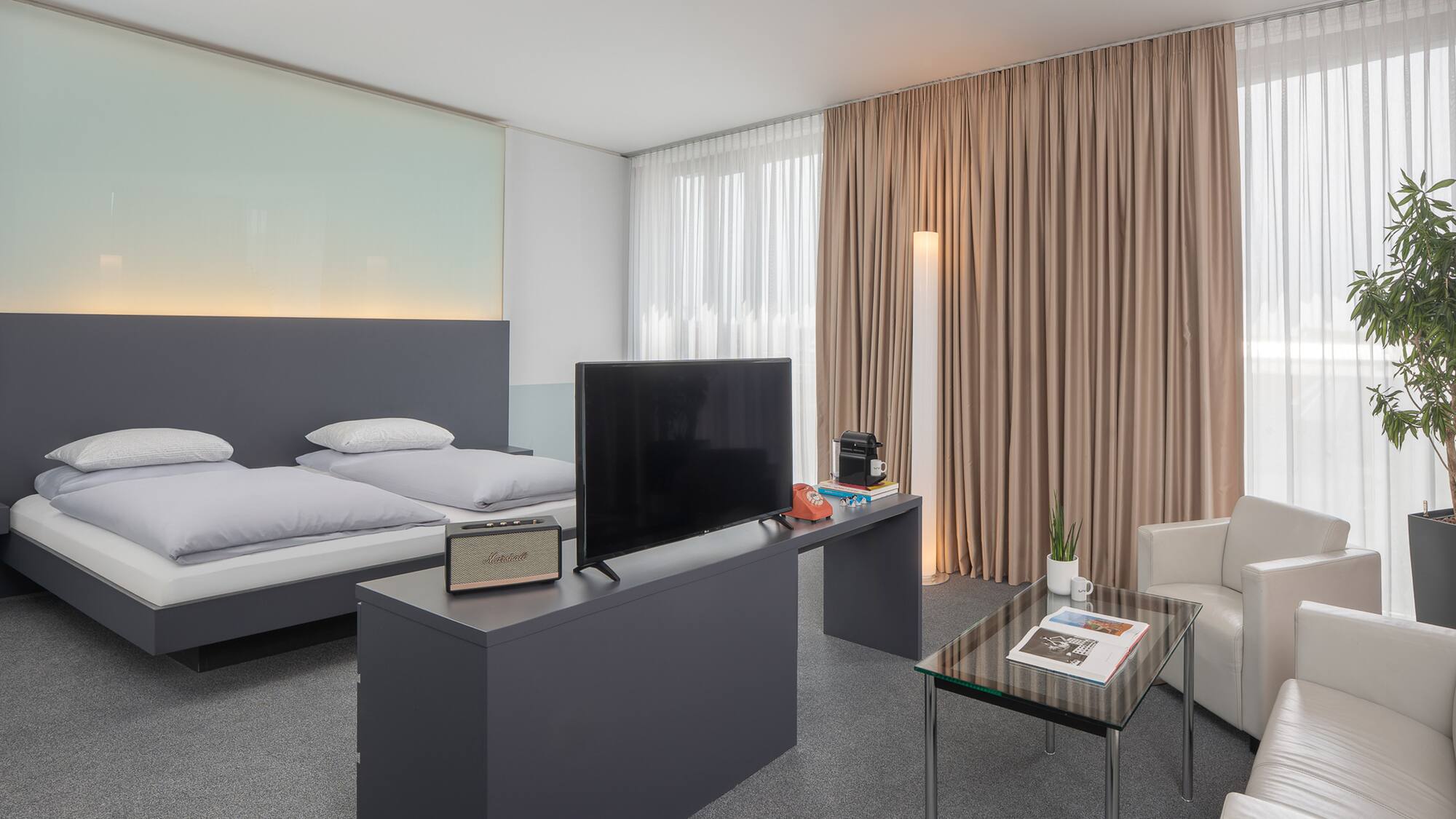 a room with a bed and a television