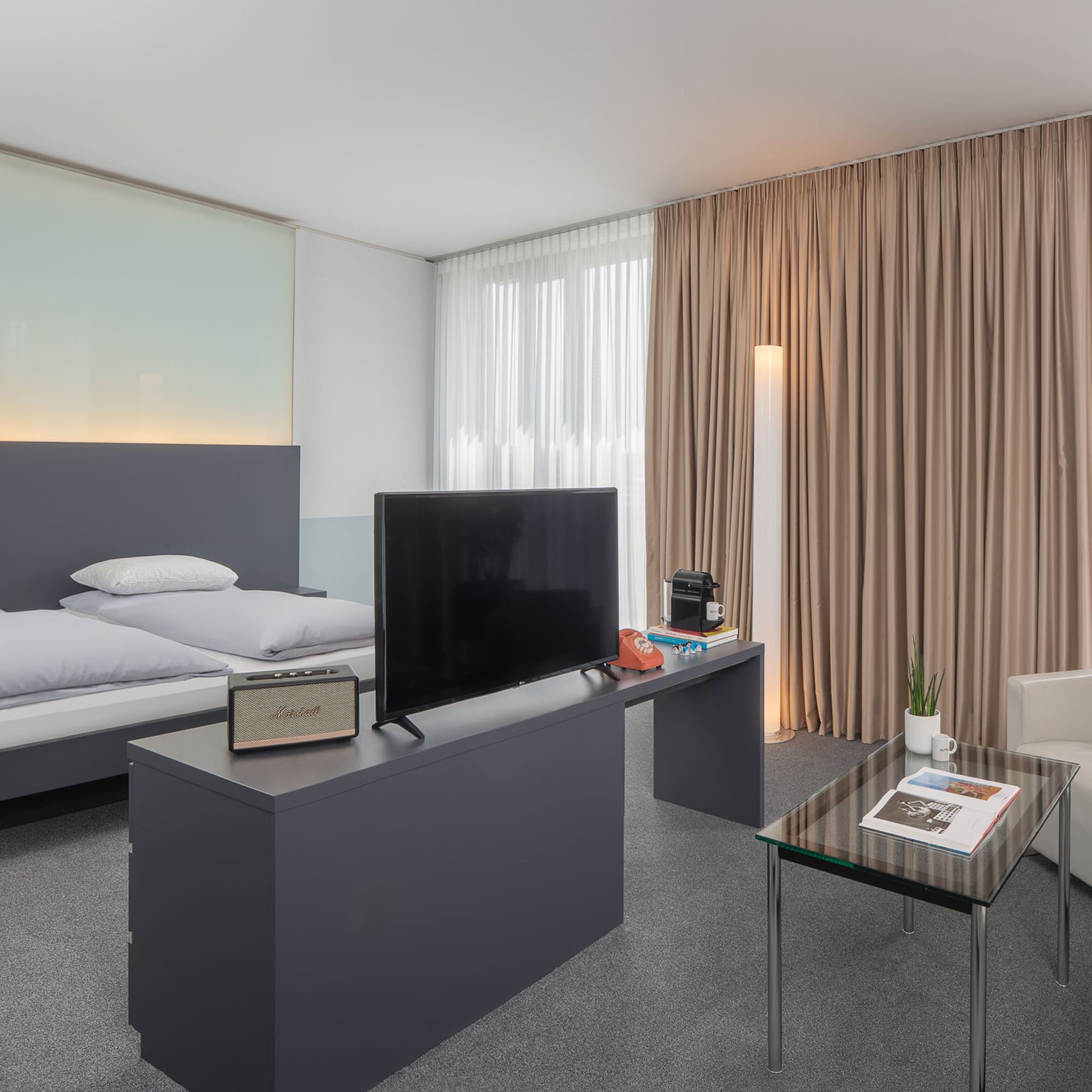 a room with a bed and a television