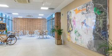 a room with a large painting on the wall