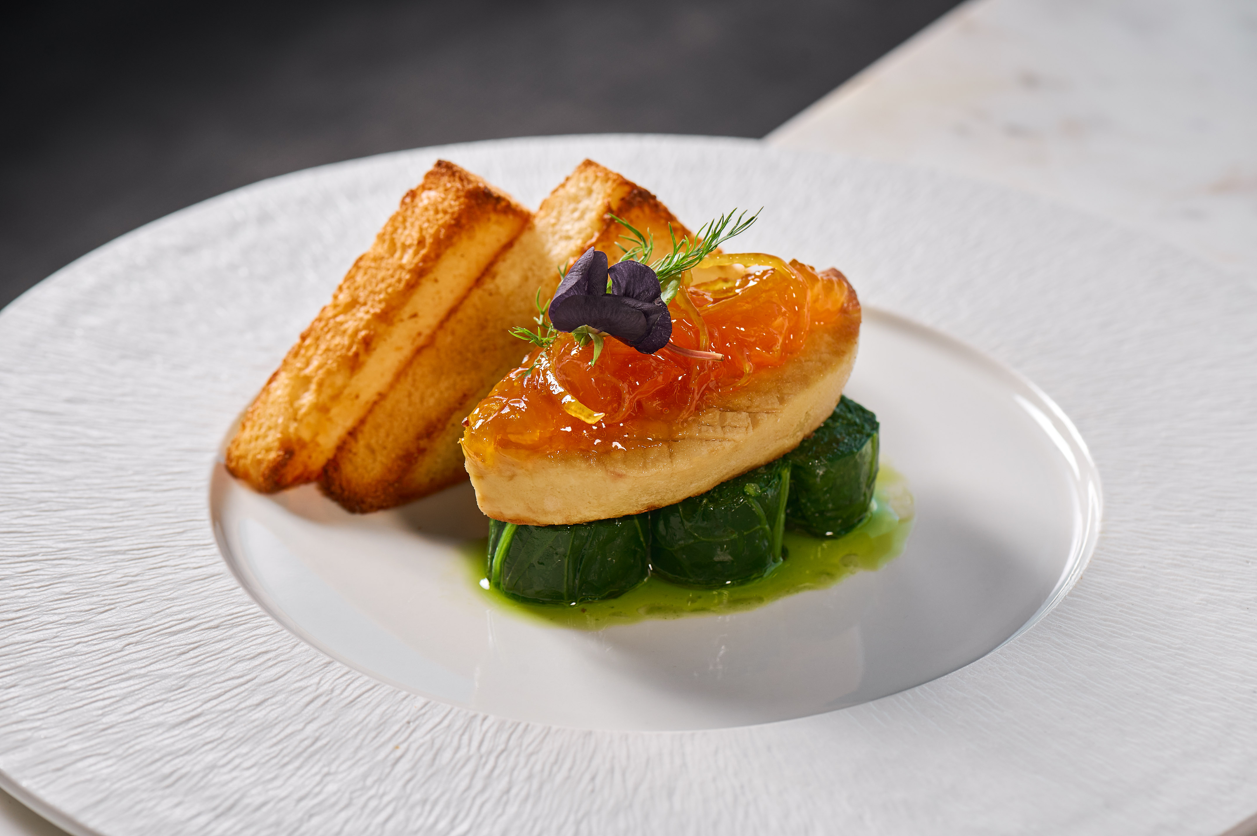 Gourmet foie gras, citrus glaze, green vegetable rolls, and toasted brioche.