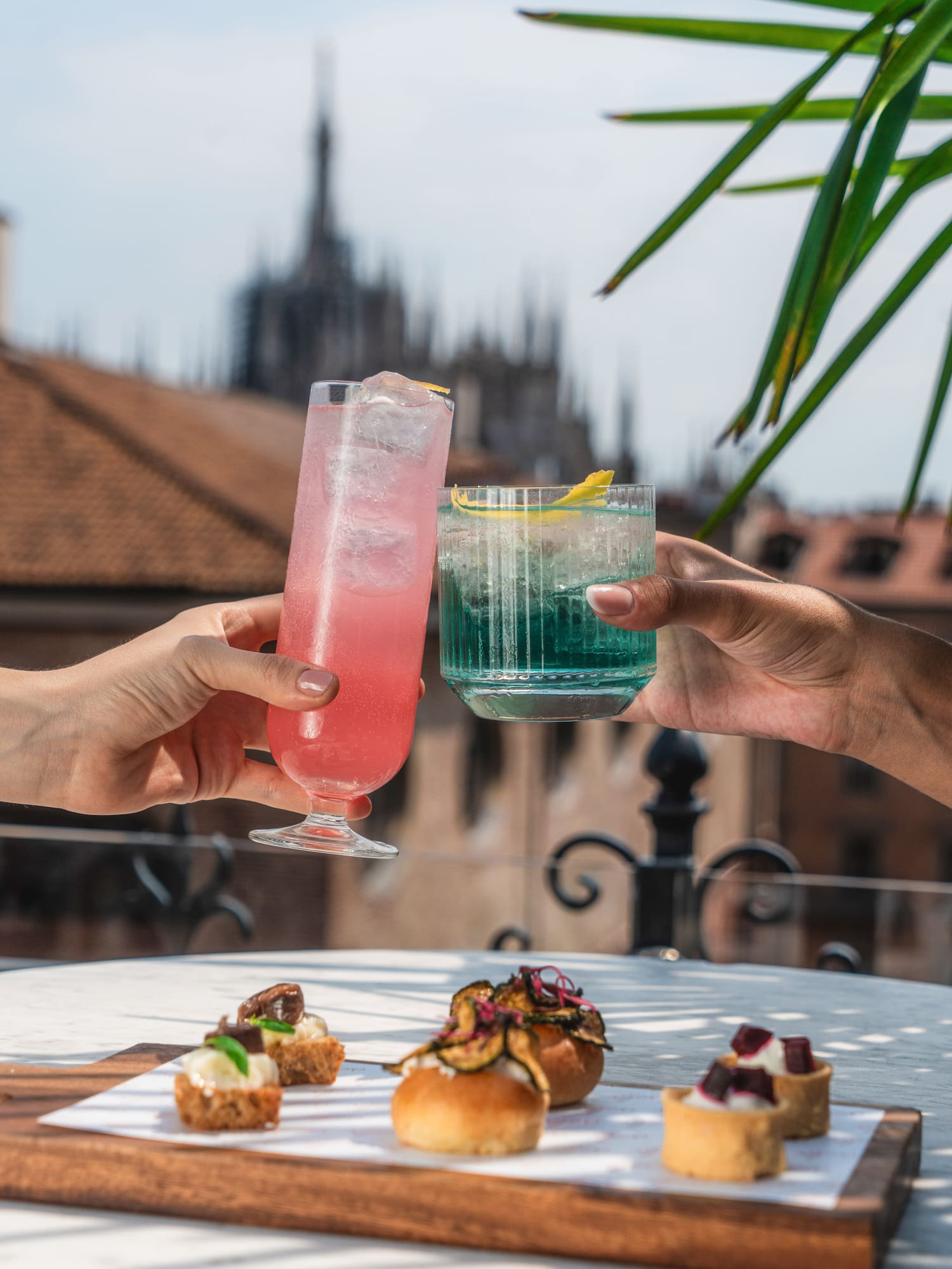 a pair of hands holding drinks