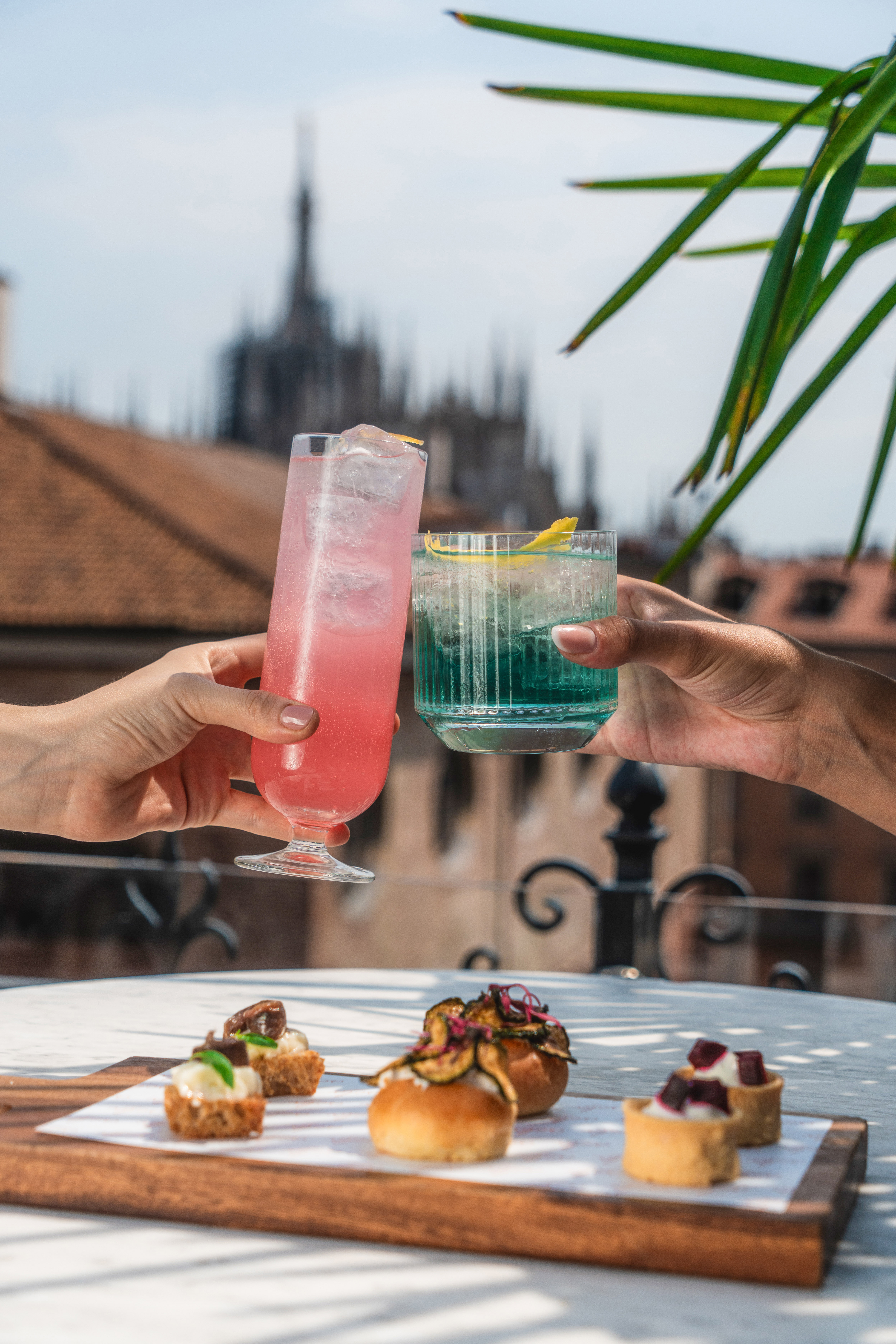 a pair of hands holding drinks