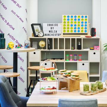 a room with a table and chairs and a board game