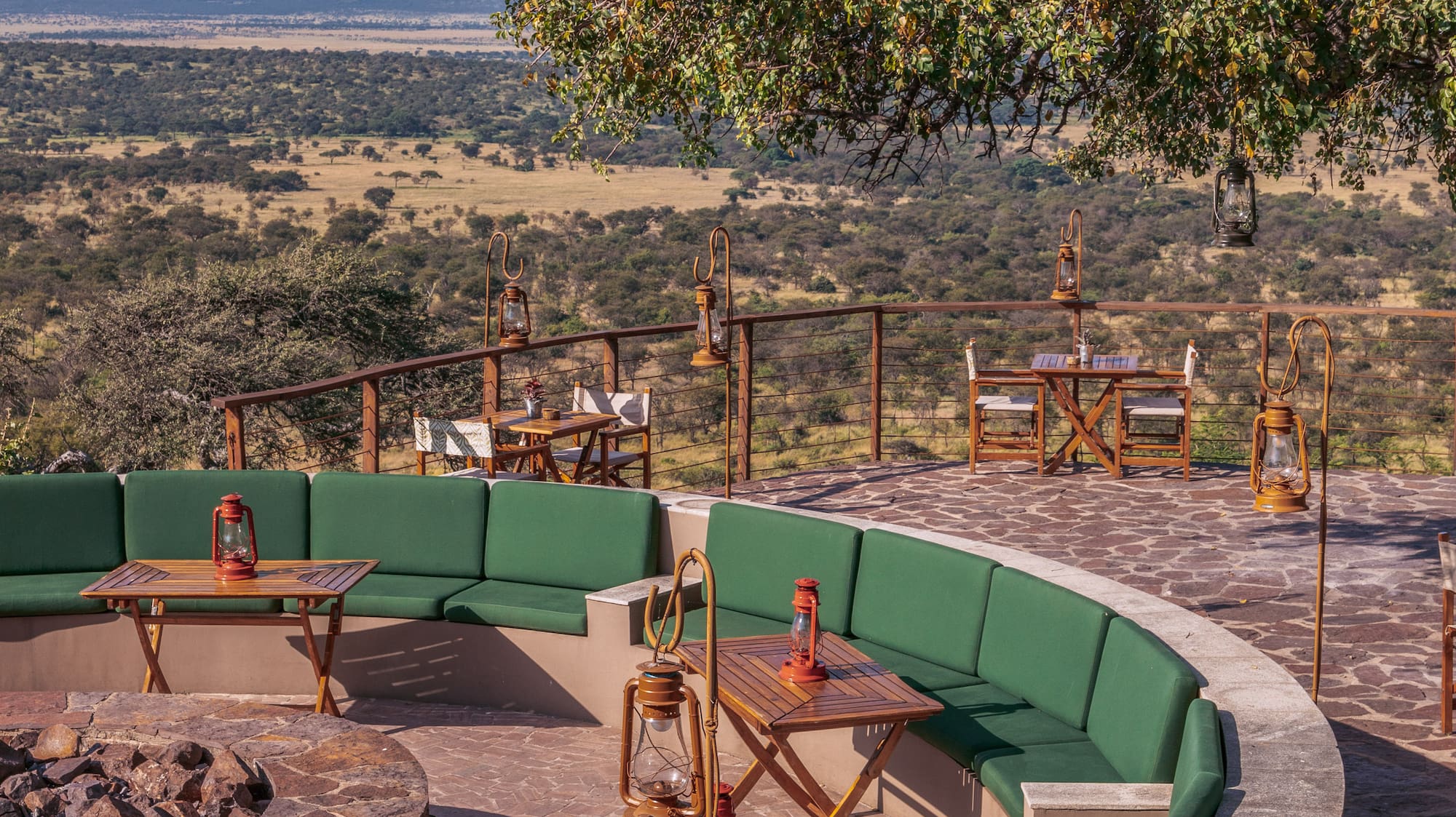 a patio with a fire pit and tables and chairs