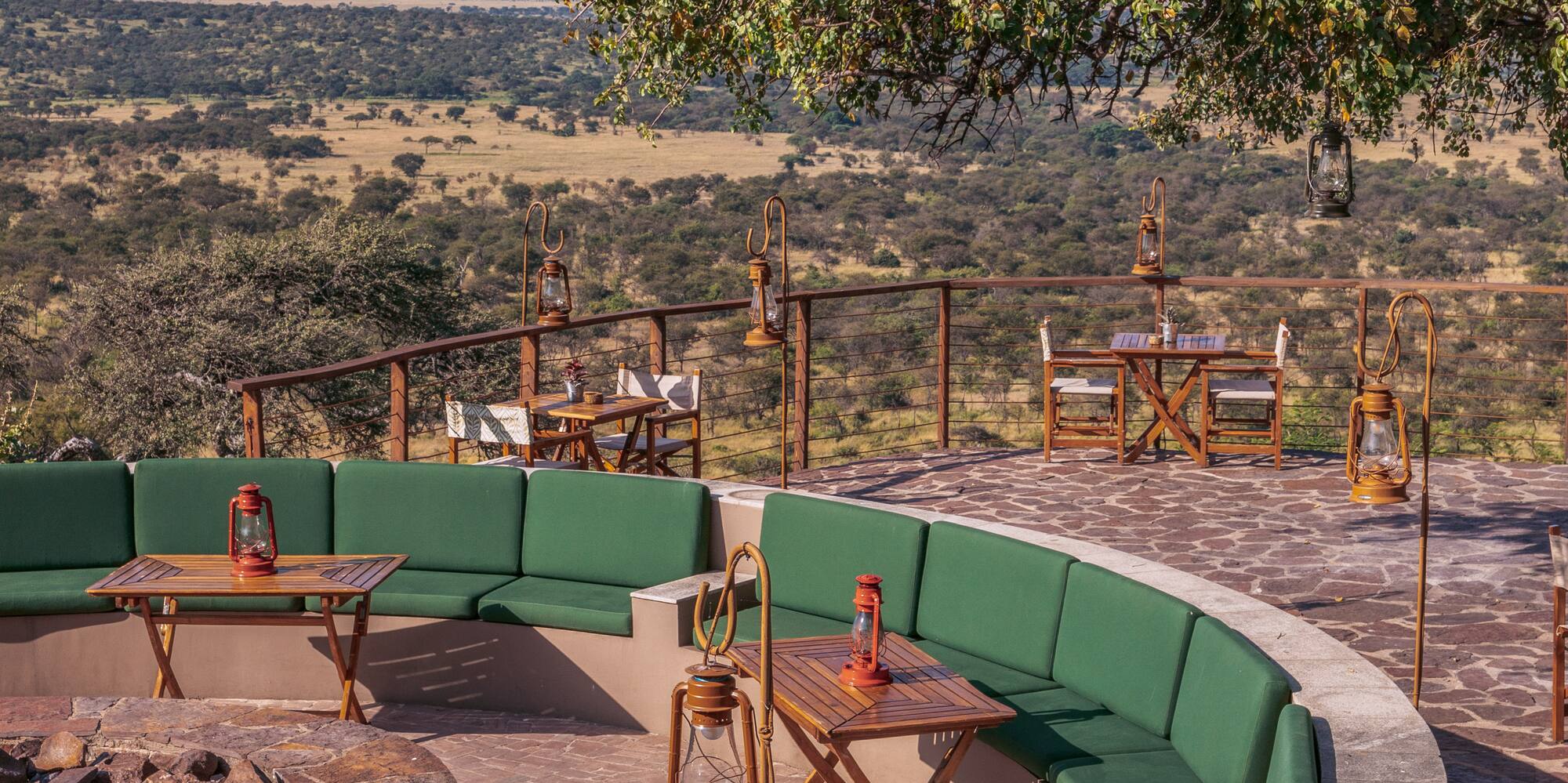 a patio with a fire pit and tables and chairs
