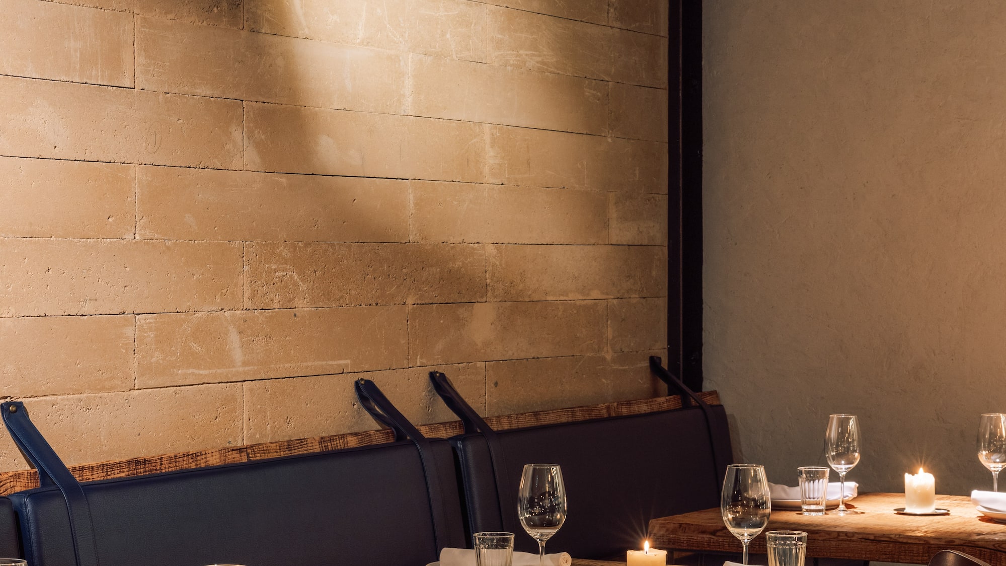 a table set up with candles and glasses