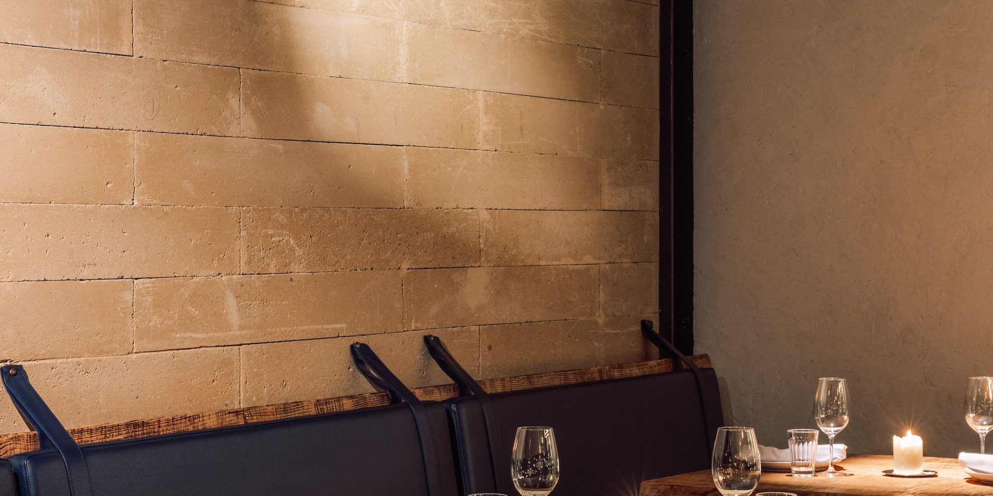 a table set up with candles and glasses
