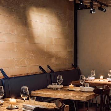 a table set up with candles and glasses