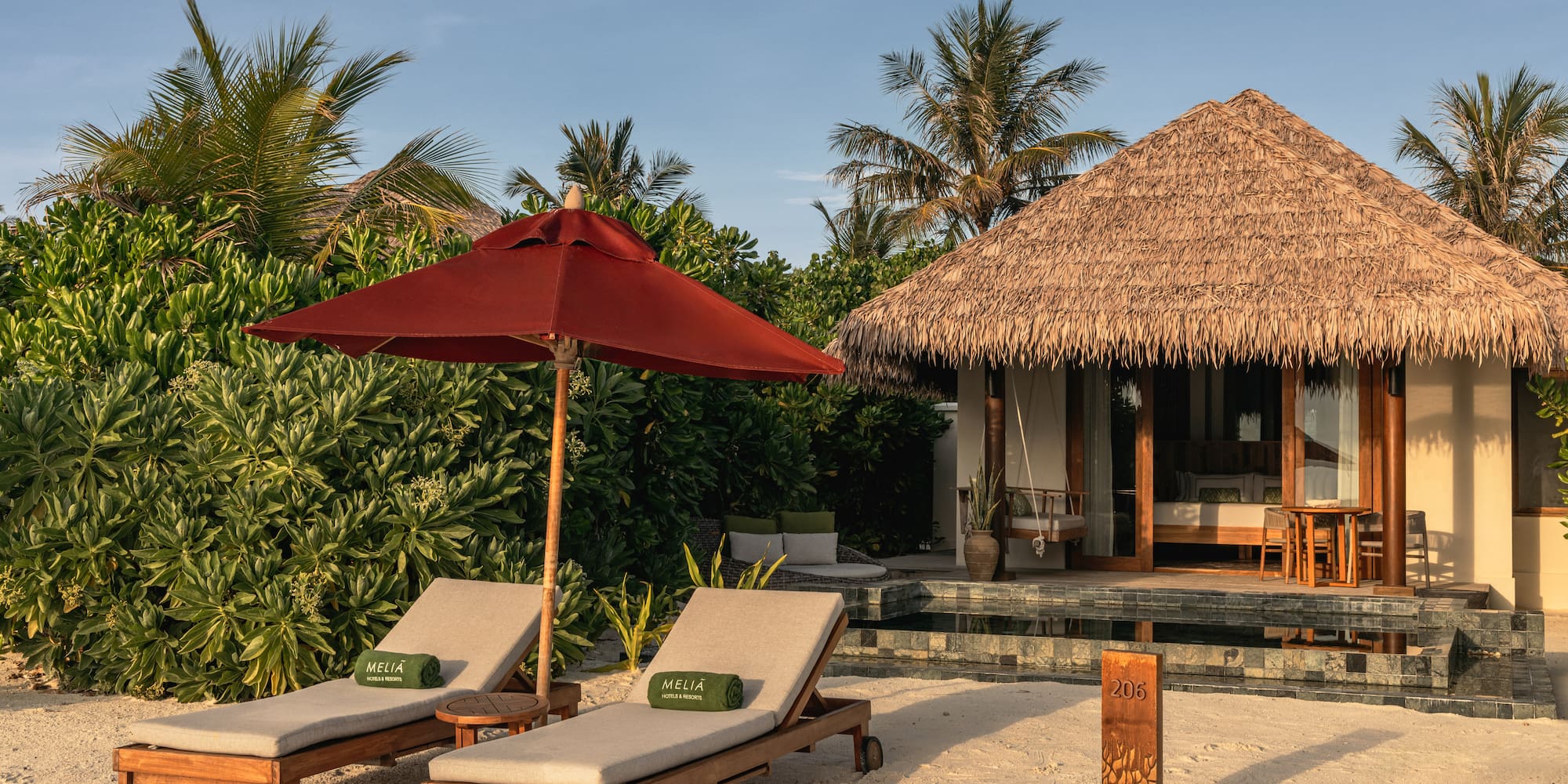 a beach chairs and umbrella on a beach