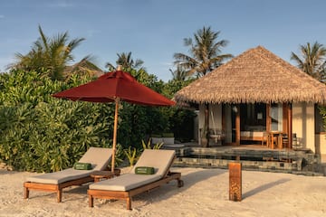 a beach chairs and umbrella on a beach