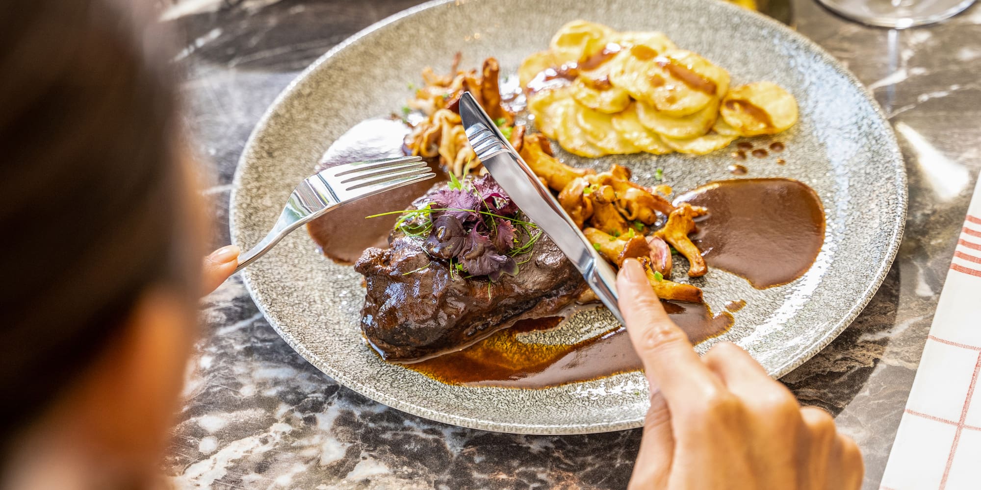 a person eating food on a plate