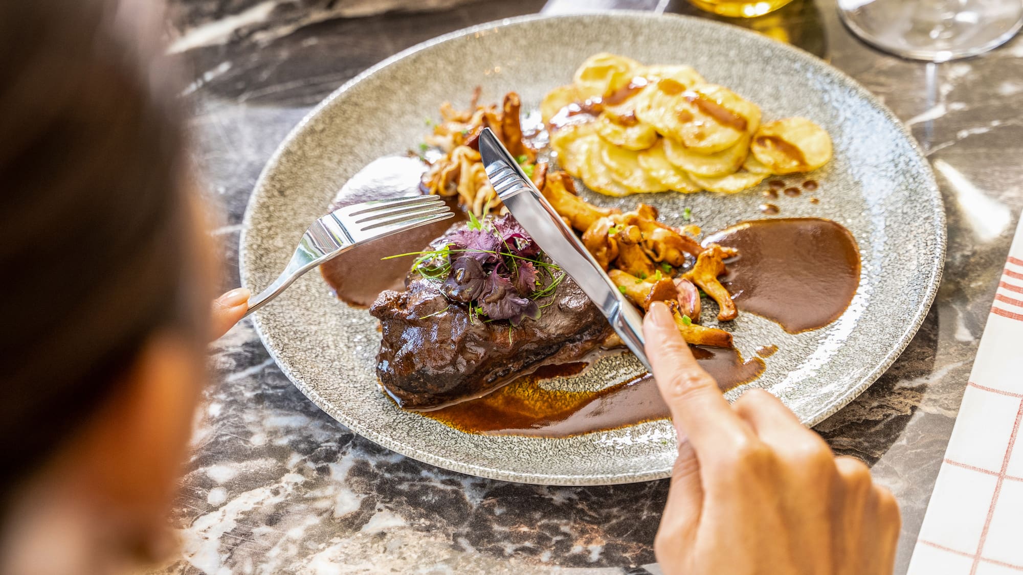 a person eating food on a plate