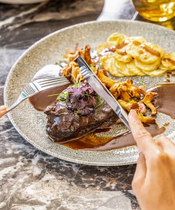 a person eating food on a plate