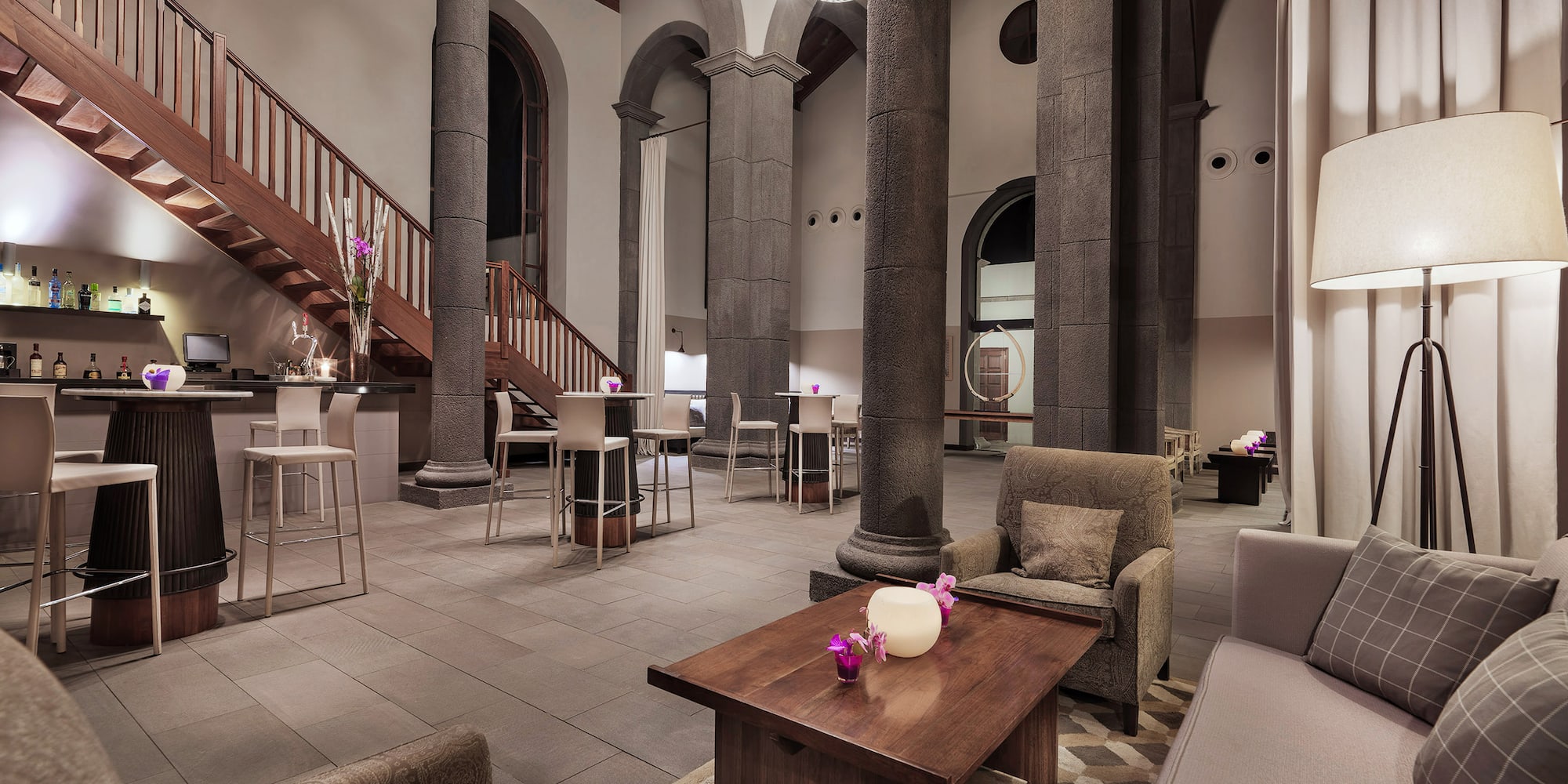 a room with columns and a table and chairs